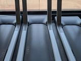 three tread machines in a row in a gym