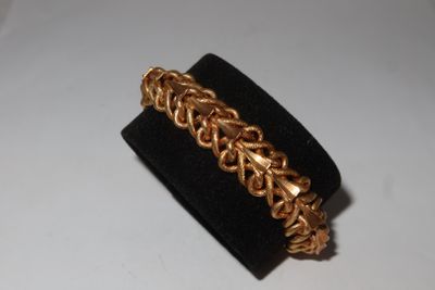 a close up of a gold bracelet on a black ring