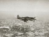 a black and white photo of an airplane flying over the ocean