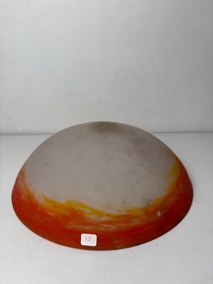 a large orange and white bowl sitting on a white surface