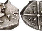 an image of a silver coin with a face on it