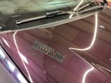 a close up of a car ' s hood with a sticker on it