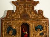 a statue of a woman and a child in a small shrine