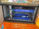 an image of a refrigerator that has a blue tray inside of it