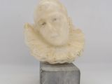 an image of a sculpture of a woman ' s head on a marble block