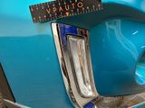 a close up of a blue car with a ruler on it