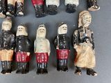 many figurines of people that are standing in a circle