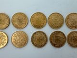 a close up of a number of coins on a white surface