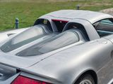 a silver sports car parked on the side of the road