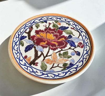 a plate with a floral design on it on a table