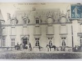 a black and white photo of a building with horses outside