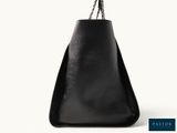 a black bag with a chain hanging from it ' s side