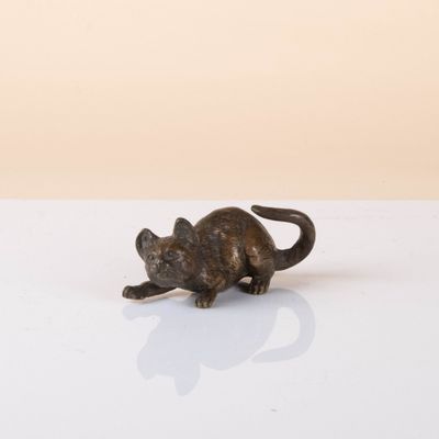 a small statue of a cat sitting on a table