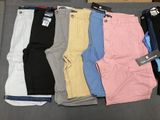 several pairs of men ' s shorts sitting on top of a table
