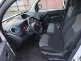 the interior of a small car with a steering wheel and a dashboard