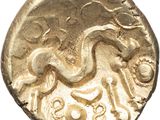 a close up of a gold coin with a horse on it