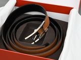 a box with a belt and a hat inside of it