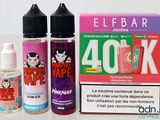 deux flacons de liquide et une boîte d'e-liquide posés sur une table