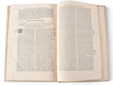 an open book on a white surface with a white background