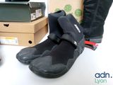 a pair of black shoes sitting on a table next to boxes