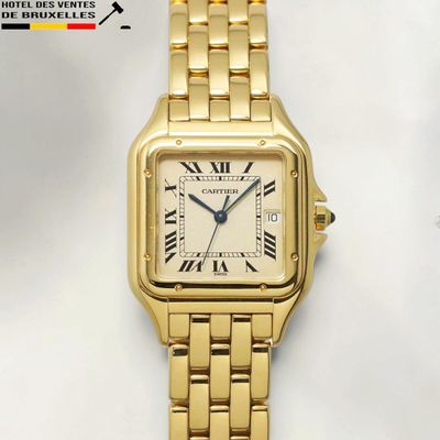 a close up of a gold wrist watch with roman numerals