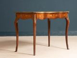 a small wooden table with a marble top on it