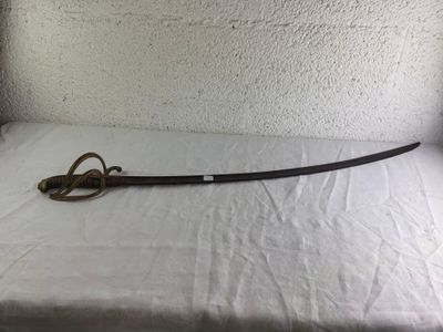 a sword that is laying on a bed with a white sheet