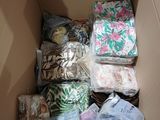 a cardboard box filled with many different types of clothing