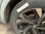a close up of a car tire with a sticker on it