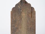 an old wooden cutting board sitting on top of a white surface