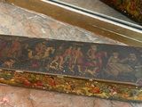 a small box with a painting on it sitting on a table