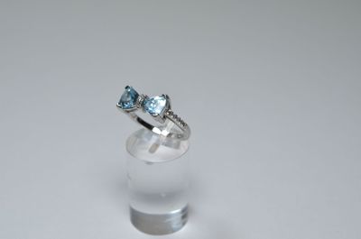 an image of a white gold ring with a blue topaz stone