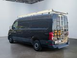 a black van with a ladder on the back of it