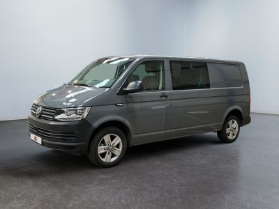 the grey van is parked in a room with a black floor