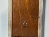 an old wooden picture frame hanging on a wall with a cat on it