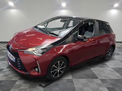 a red toyota yaris parked on a checkered floor