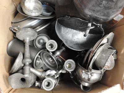 a cardboard box full of old metal items in it