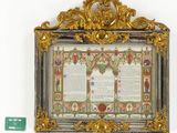 a gold frame with a picture of a man and a woman on it
