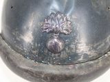 a silver vase with a flower on it sitting on a table