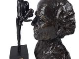 statue of a woman with a child on her lap and a statue of a man holding a baby
