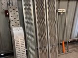 a pile of metal grates sitting in a warehouse