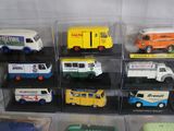 a lot of different types of toy trucks in a display case