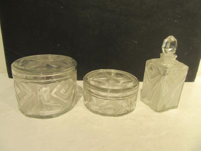 three glass jars sitting on a table next to each other
