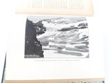 an open book with a picture of a man on a mountain