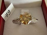 a yellow diamond ring in a red box with a price tag