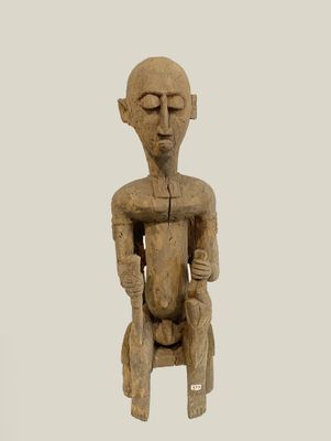 statue of a man sitting on a chair with his eyes closed