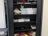 a black cabinet with many items in it in a room