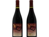 two bottles of wine sitting next to each other on a white surface