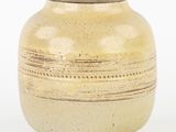 a vase that is sitting on a white surface