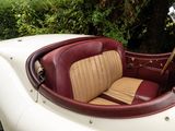 a white car with a red seat and a brown seat